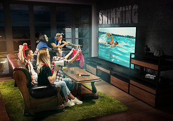 Image showing Group of friends watching TV, swimming, sport games