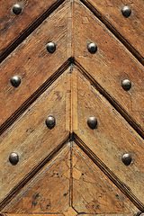 Image showing Fragment of old wooden doors with metal rivets