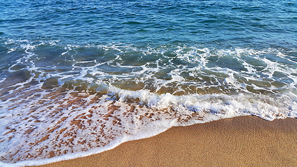 Image showing Sea water with white foam in the coastal sand