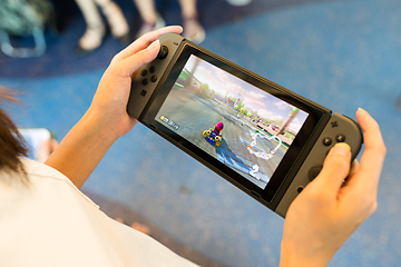 Image showing Hong Kong, 19 May 2017 -:Woman Playing mario kart 8 on Nintendo 