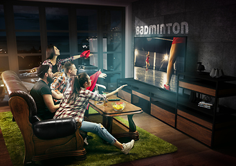 Image showing Group of friends watching TV, badminton match, sport games