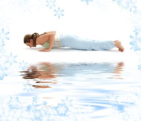 Image showing chaturanga dandasana four-limbed staff pose on white sand