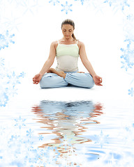 Image showing padmasana lotus pose on white sand