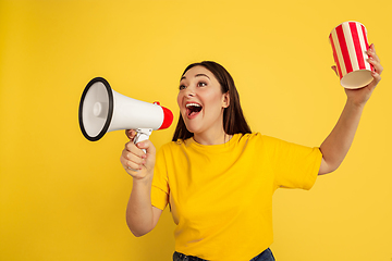 Image showing Caucasian woman\'s portrait isolated on yellow studio background