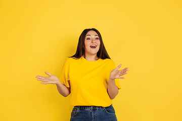 Image showing Caucasian woman\'s portrait isolated on yellow studio background