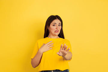 Image showing Caucasian woman\'s portrait isolated on yellow studio background