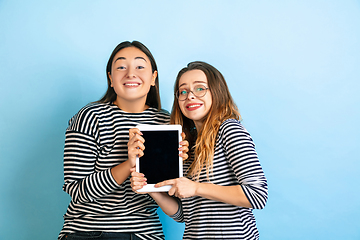 Image showing Young emotional women on gradient blue background