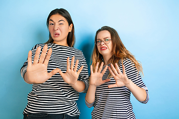 Image showing Young emotional women on gradient blue background