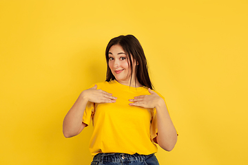 Image showing Caucasian woman\'s portrait isolated on yellow studio background