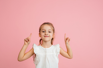 Image showing Pretty caucasian girl portrait isolated on pink studio background with copyspace