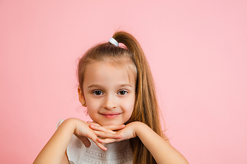 Image showing Pretty caucasian girl portrait isolated on pink studio background with copyspace