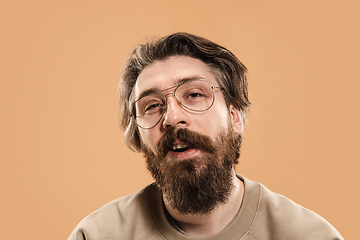 Image showing Half-length portrait of Caucasian man isolated over light yellow background.