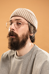 Image showing Portrait of Caucasian man in glasses and hat isolated on light background.