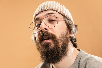 Image showing Portrait of Caucasian man in glasses and hat isolated on light background.