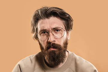 Image showing Half-length portrait of Caucasian man isolated over light yellow background.