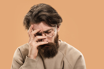 Image showing Half-length portrait of Caucasian man isolated over light yellow background.