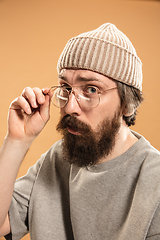 Image showing Portrait of Caucasian man in glasses and hat isolated on light background.