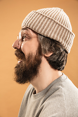 Image showing Portrait of Caucasian man in glasses and hat isolated on light background.