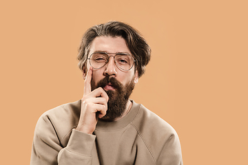 Image showing Half-length portrait of Caucasian man isolated over light yellow background.