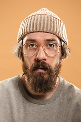 Image showing Portrait of Caucasian man in glasses and hat isolated on light background.