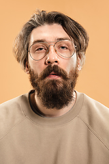 Image showing Half-length portrait of Caucasian man isolated over light yellow background.