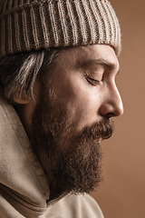 Image showing Close-up Caucasian mustached and bearded man in hat isolated on light background