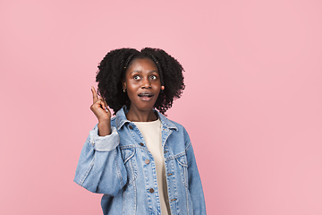 Image showing African-american woman portrait isolated on pink studio background with copyspace