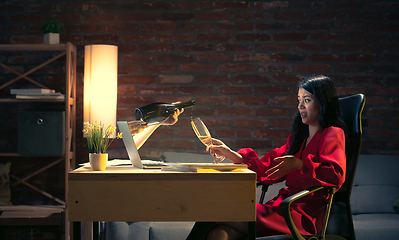 Image showing Young Caucasian woman talking with friend online through laptop.