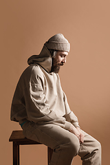 Image showing Half-length portrait of Caucasian man isolated over light yellow background.