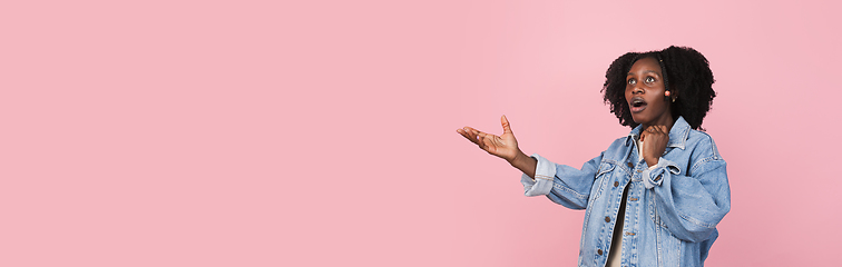 Image showing African-american woman portrait isolated on pink studio background with copyspace