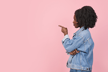 Image showing African-american woman portrait isolated on pink studio background with copyspace