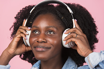 Image showing African-american woman portrait isolated on pink studio background with copyspace