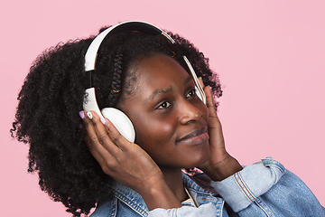 Image showing African-american woman portrait isolated on pink studio background with copyspace