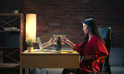 Image showing Young Caucasian woman talking with friend online through laptop.