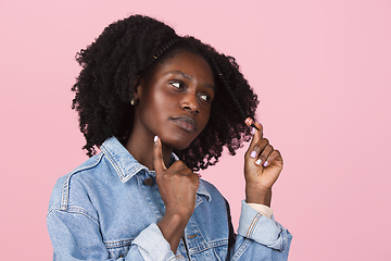 Image showing African-american woman portrait isolated on pink studio background with copyspace