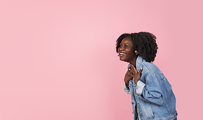 Image showing African-american woman portrait isolated on pink studio background with copyspace