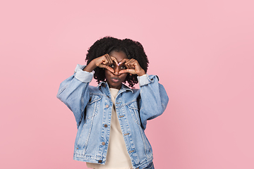 Image showing African-american woman portrait isolated on pink studio background with copyspace