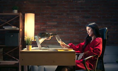 Image showing Young Caucasian woman talking with friend online through laptop.