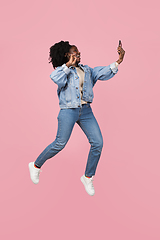 Image showing African-american woman portrait isolated on pink studio background with copyspace