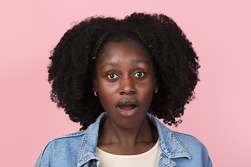 Image showing African-american woman portrait isolated on pink studio background with copyspace