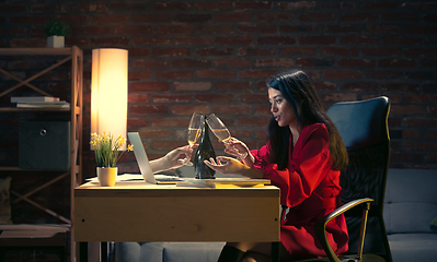 Image showing Young Caucasian woman talking with friend online through laptop.