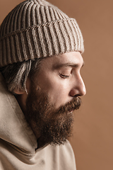 Image showing Close-up Caucasian mustached and bearded man in hat isolated on light background