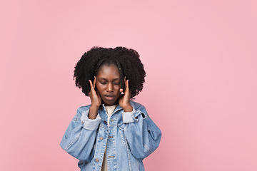 Image showing African-american woman portrait isolated on pink studio background with copyspace