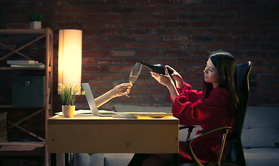 Image showing Young Caucasian woman talking with friend online through laptop.