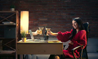 Image showing Young Caucasian woman talking with friend online through laptop.