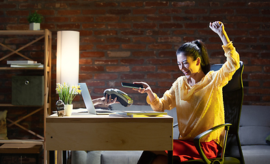 Image showing Young Caucasian woman using online banking through laptop.