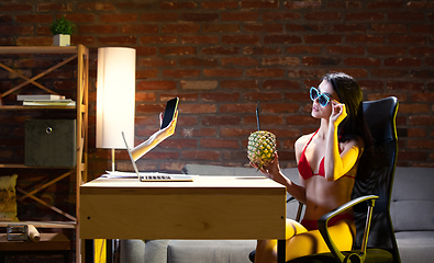 Image showing Young Caucasian woman talking with friend online through laptop.