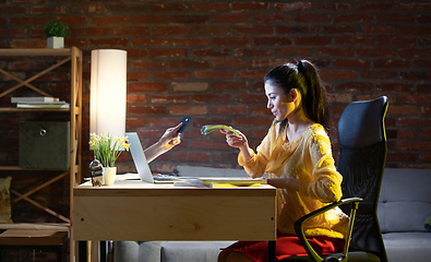 Image showing Young Caucasian woman using online banking through laptop.