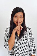 Image showing young asian with finger on her lips