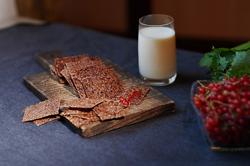 Image showing Vegan flaxseed bread with berries next to the glass with coconut